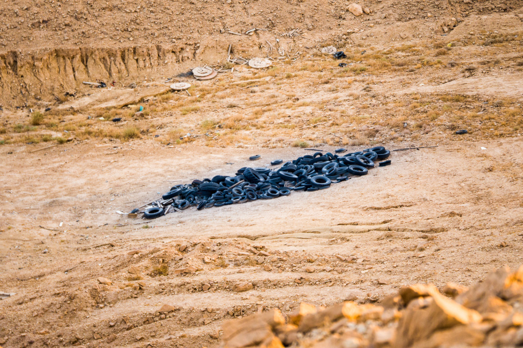 Tires in the desert swept by the river (when it rains).